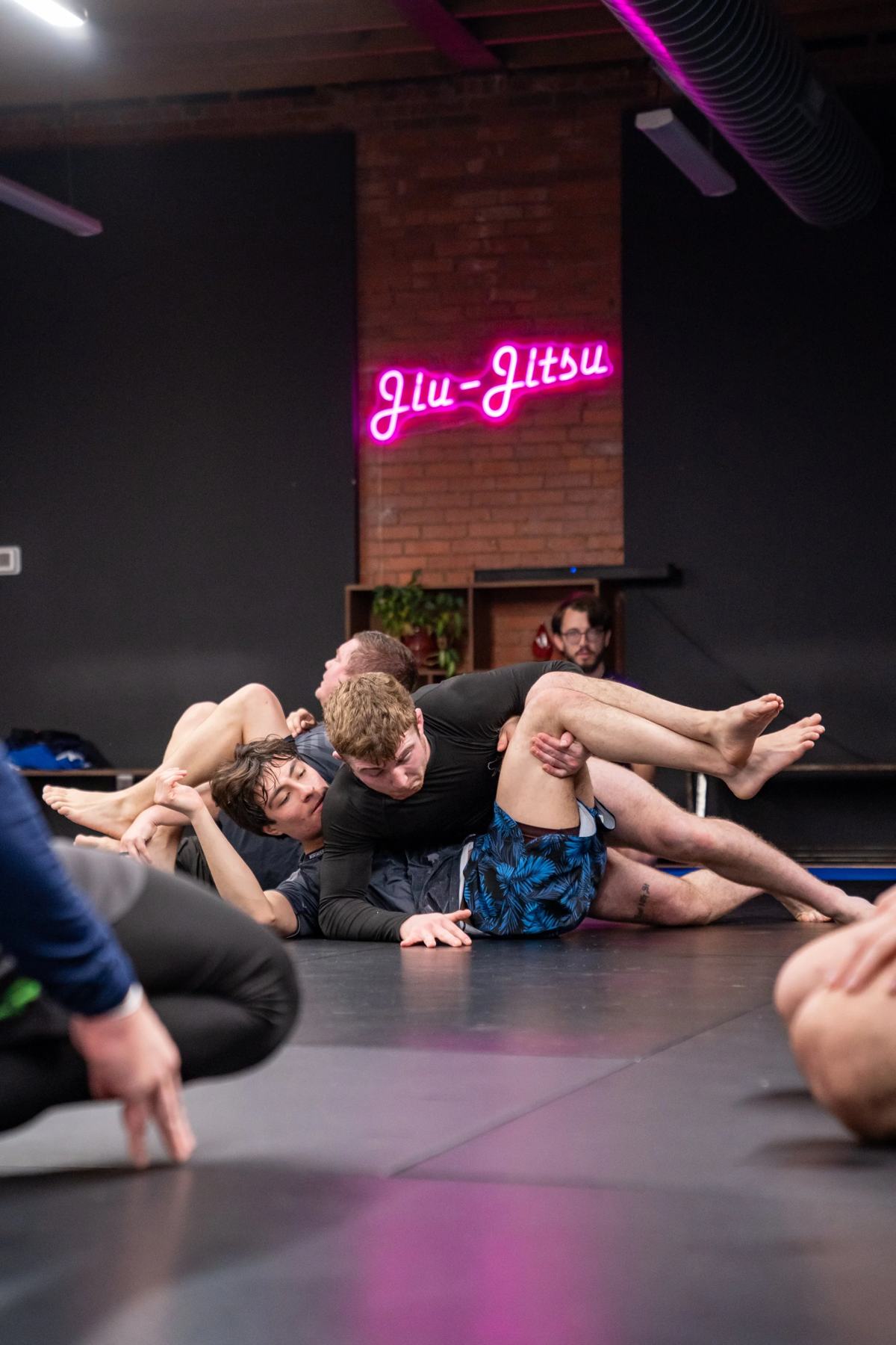 The Jiu-Jitsu neon sign on the brick wall at Renzo Gracie Des Moines